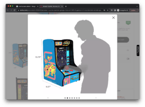 screenshot of a online photo of a retro korean treat distributing arcade game. There is a shadow of a man interacting with the game in front of it 